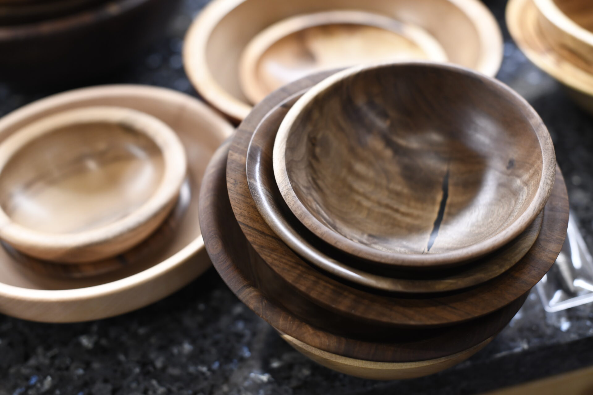 A pile of wooden bowls sitting on top of a table.