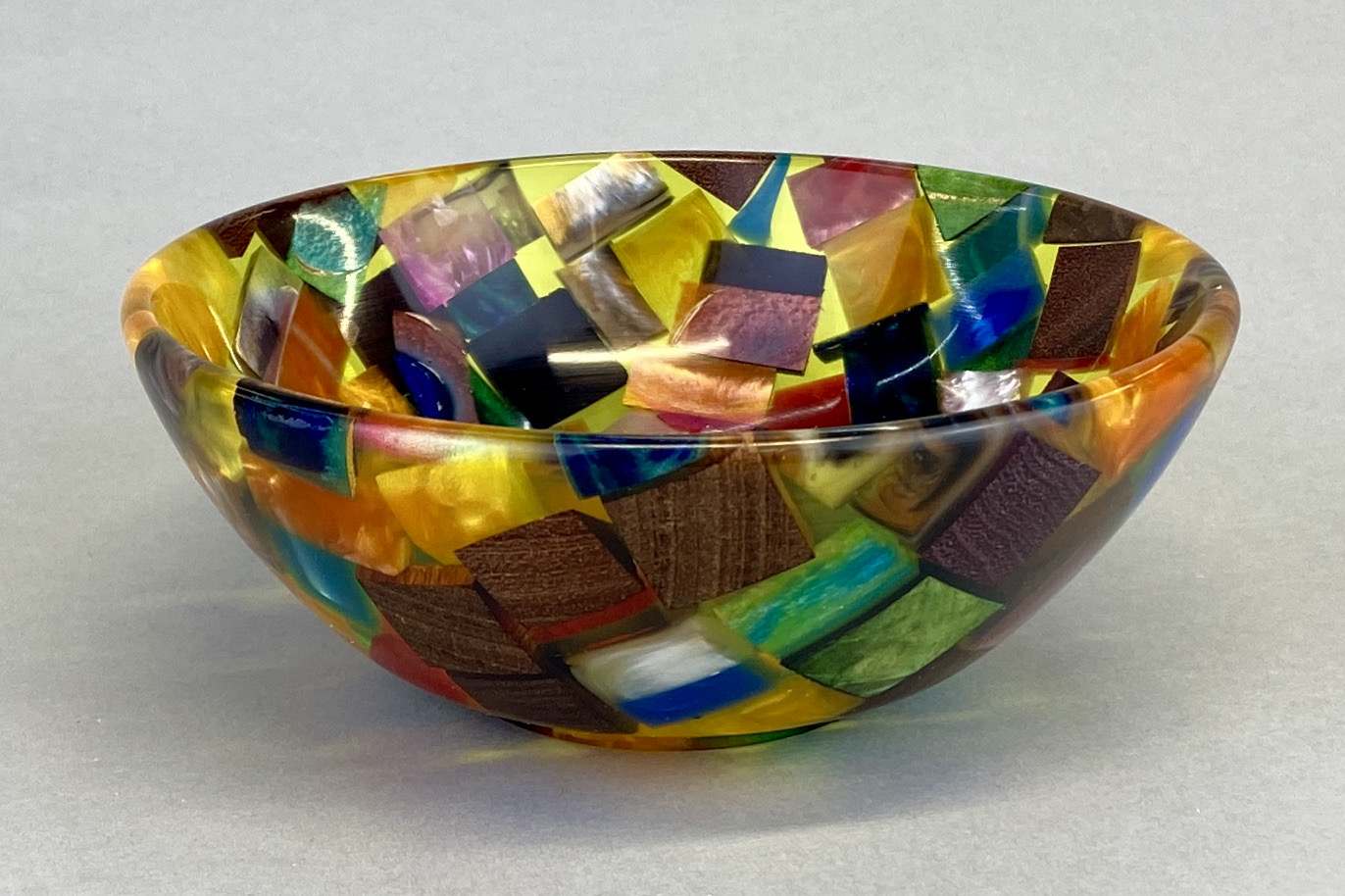 A bowl with colorful squares on it