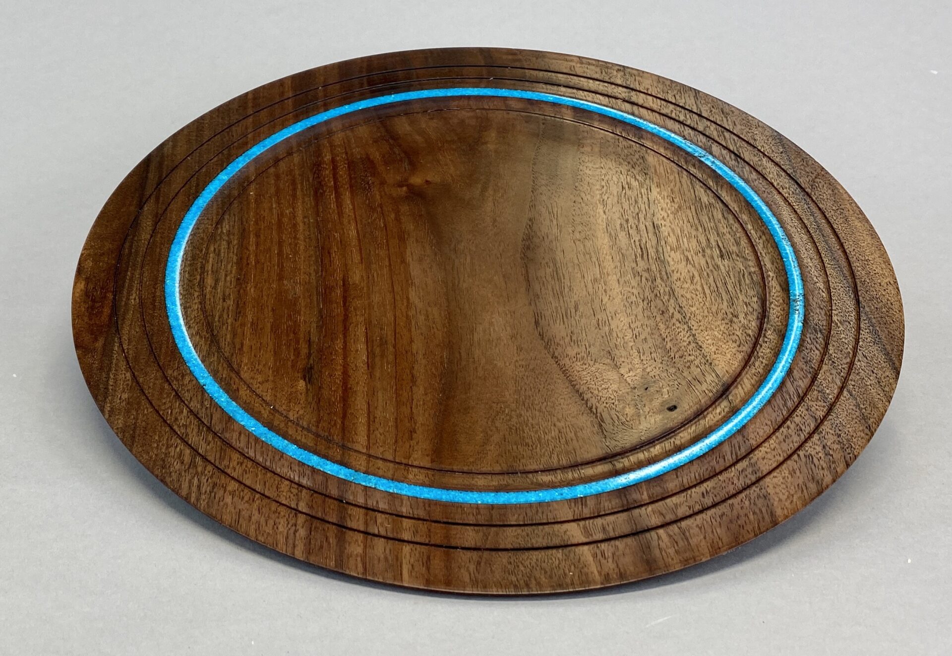 A wooden plate with blue lines on it.