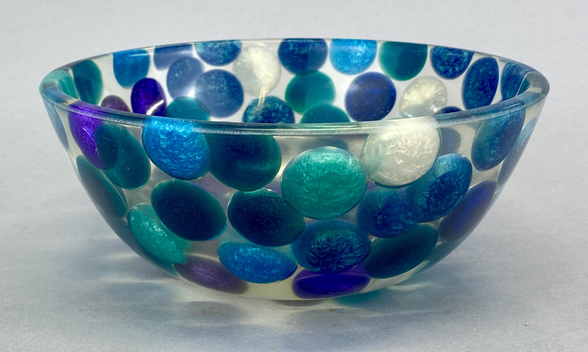 A bowl with blue and white dots on it