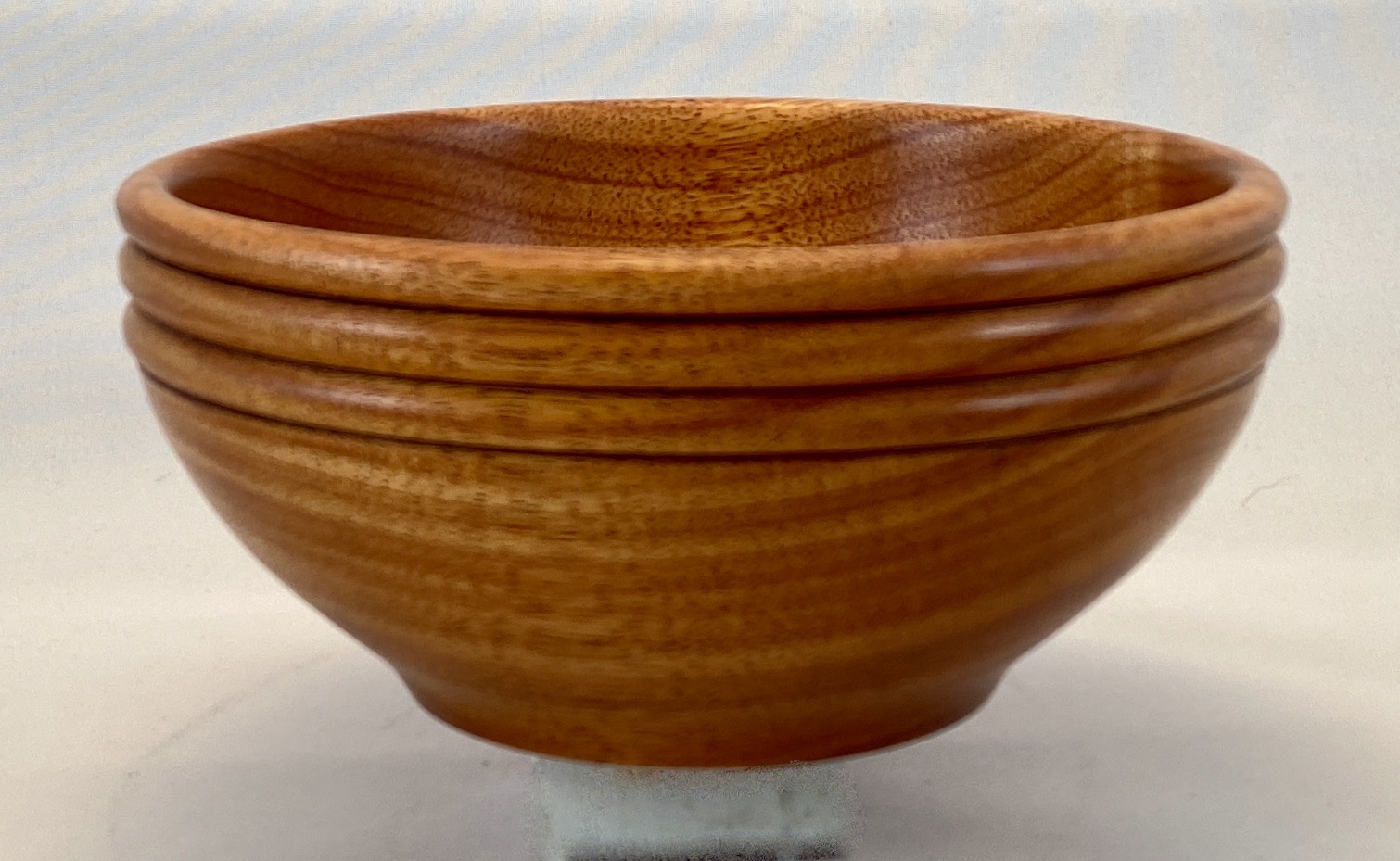 A close up of four wooden bowls on top of each other.