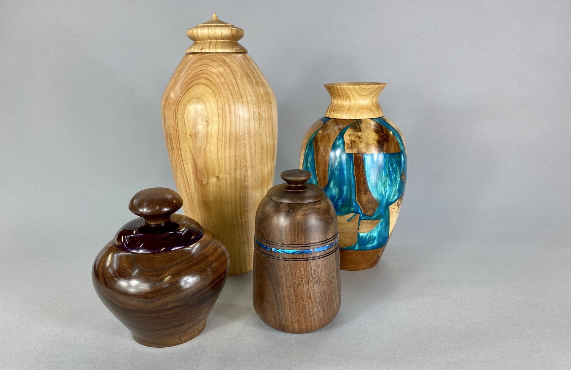 A group of four vases sitting on top of each other.