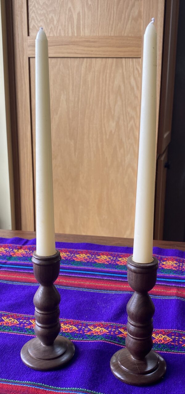 A pair of candles on top of a table.