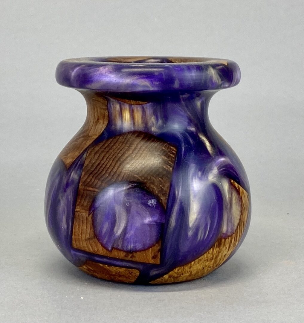 A small vase with purple and brown design.