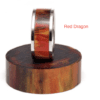 A red dragon ring on a wooden stand.