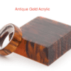 A gold ring sitting on top of a wooden block.