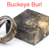 A buckeye burl wood ring sitting next to a box.