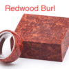 A red wood burl ring with a metal band.