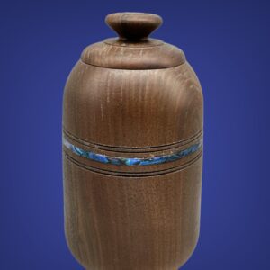 A wooden vase with a blue stripe around the bottom.