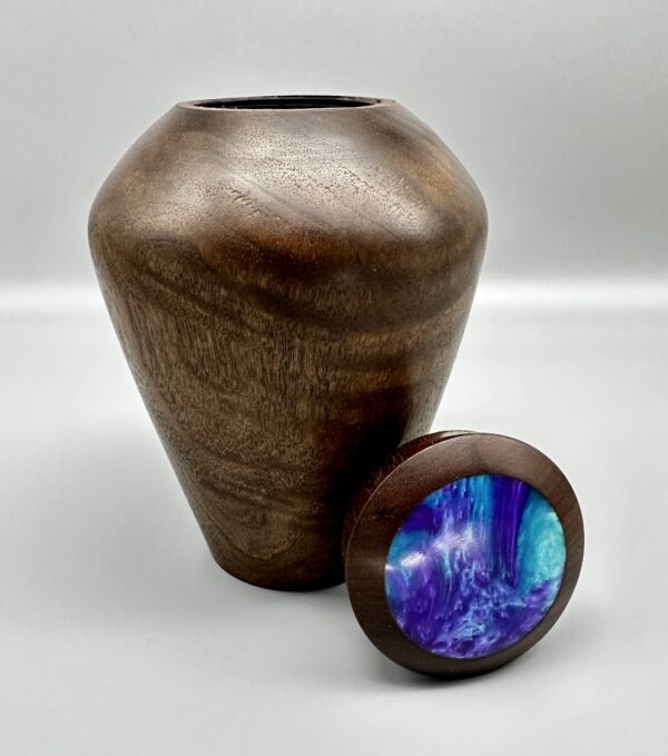 A vase and a button are shown next to each other.