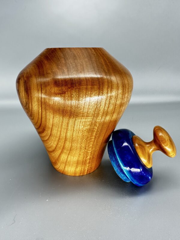 A wooden vase and a blue glass object.