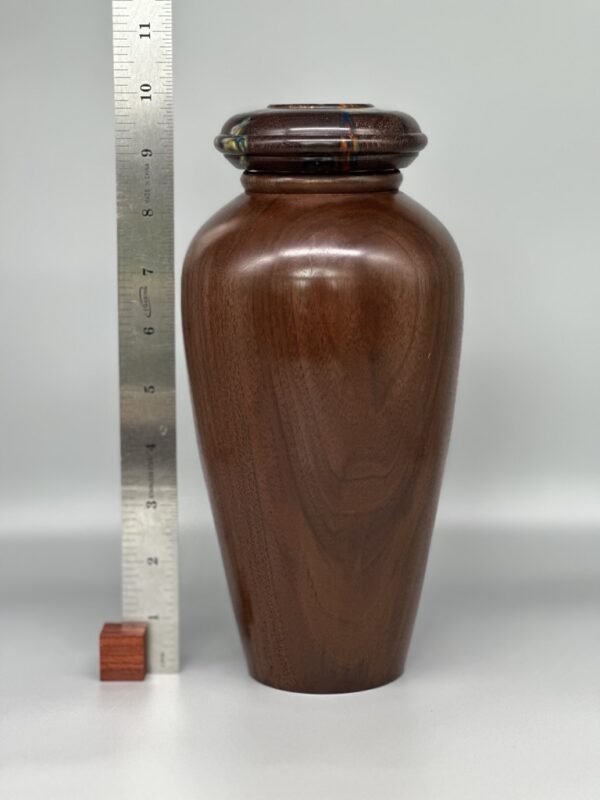 A large brown vase with a wooden lid.