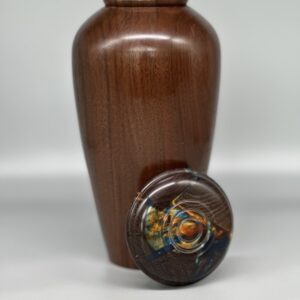 A wooden urn with a lid on top of it.