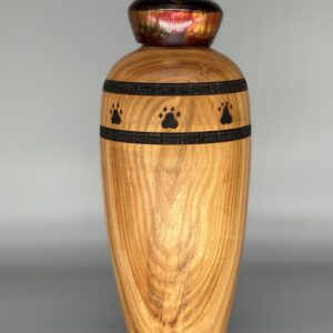 A wooden vase with black and brown designs on it.