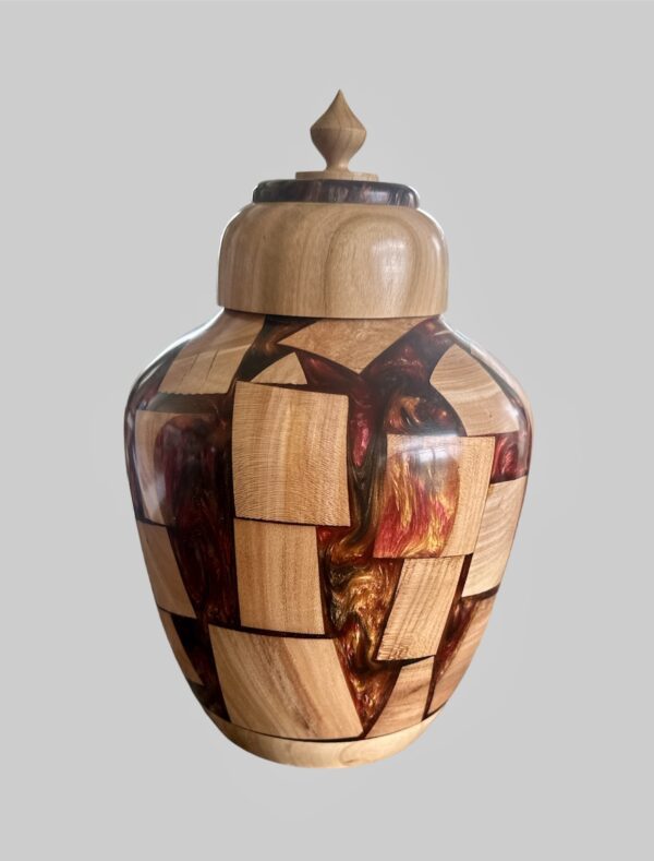 A wooden vase with a lid is shown.