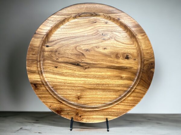 A wooden plate sitting on top of a table.