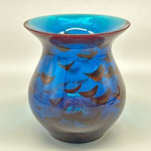 A blue vase with brown and black design on it.