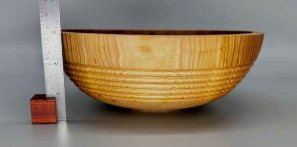 A wooden bowl with a pattern on it.