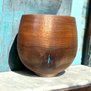 A wooden bowl sitting on top of a table.