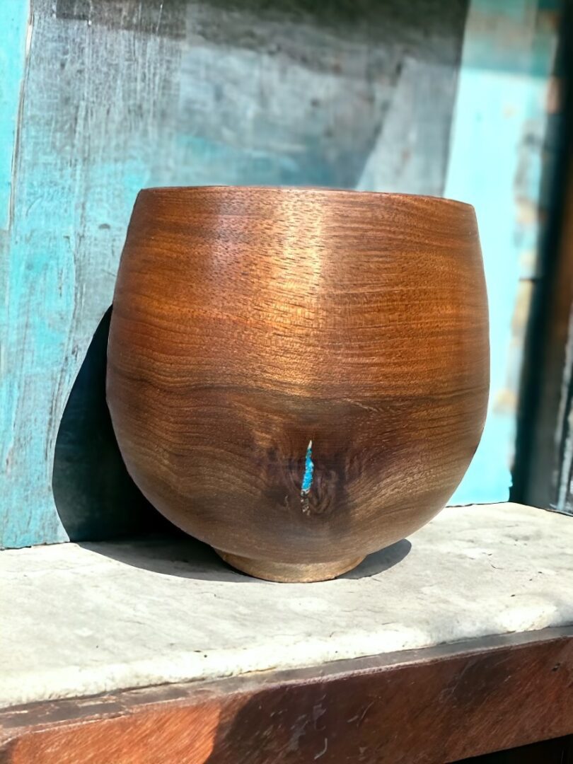 A wooden bowl sitting on top of a table.