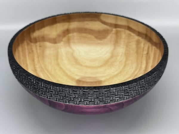 A wooden bowl with a pattern on it.