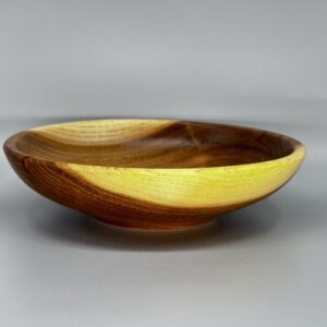 A wooden bowl with yellow inside of it