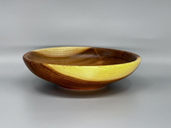 A wooden bowl with yellow inside of it