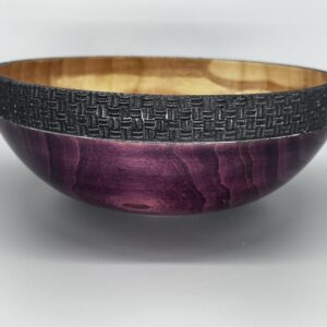A bowl with purple and black wood on top of a table.