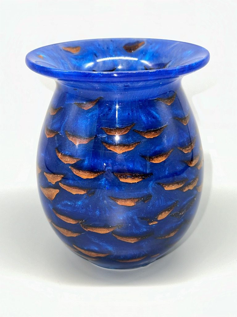 A blue vase with brown designs on it.