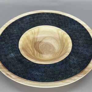 A bowl and plate with black design on it.