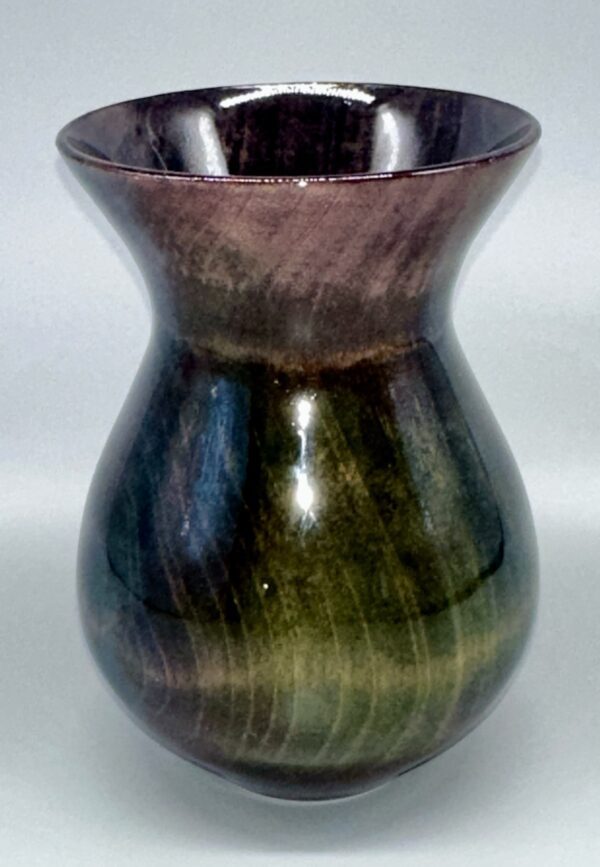 A vase with a brown and green design on it.