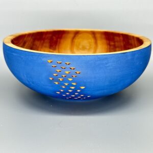 A blue bowl with gold dots on it.