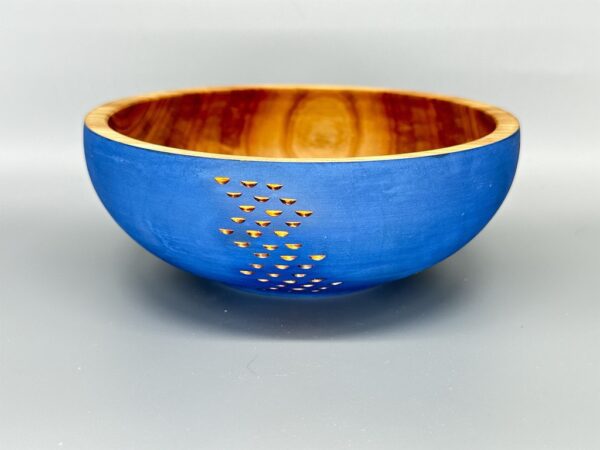 A blue bowl with gold dots on it.