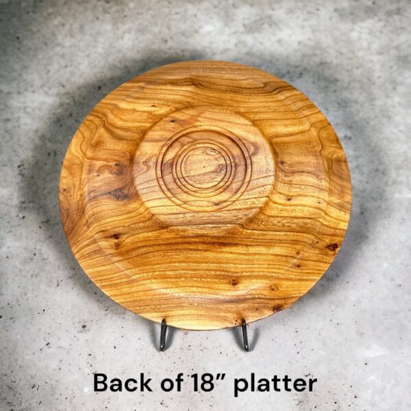 A wooden plate sitting on top of a concrete floor.