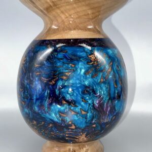 A blue vase with gold and black swirls