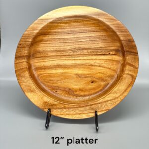 A wooden plate with a black stand on it